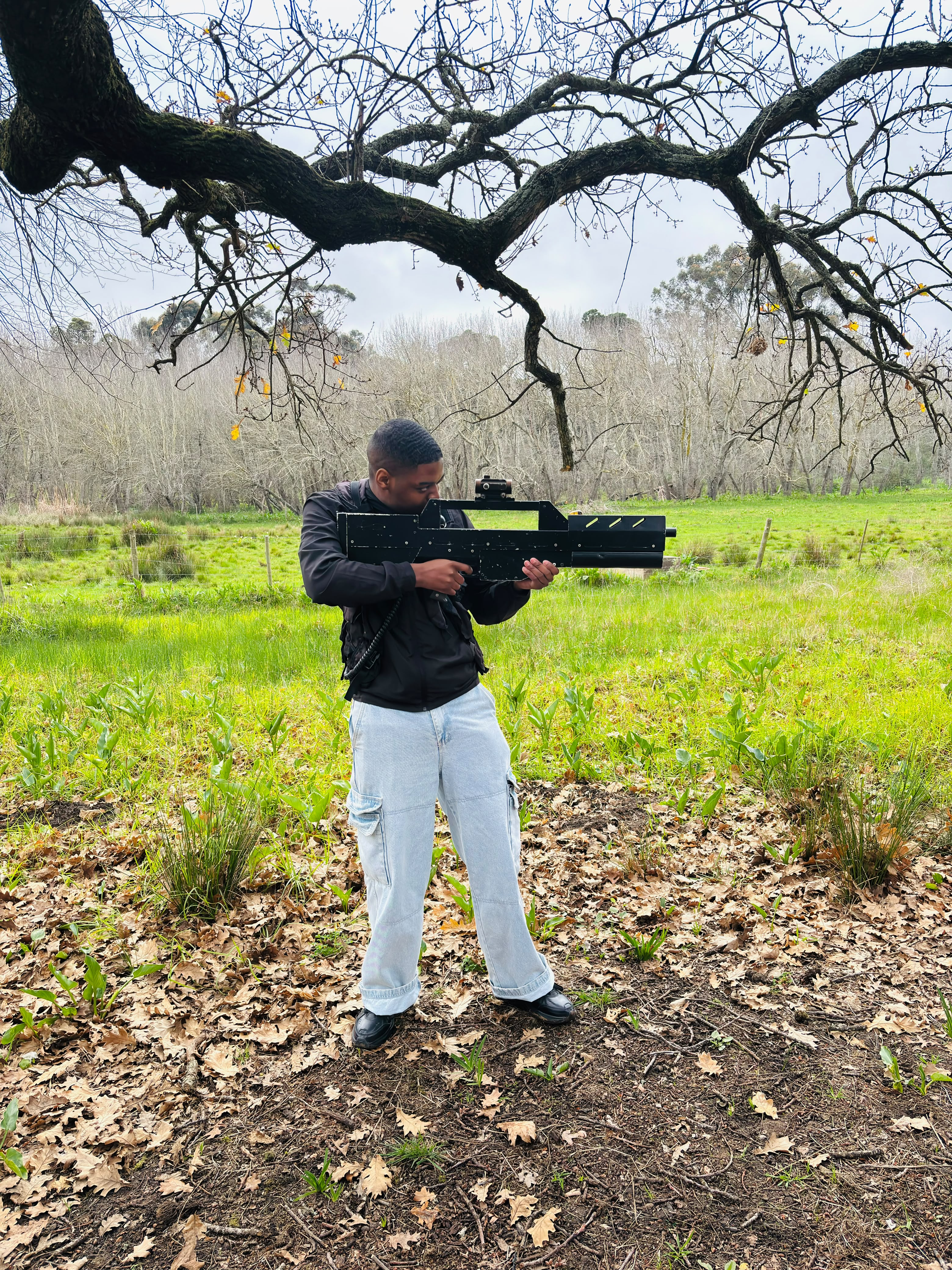 A person holding laser-tag equipment outdoors